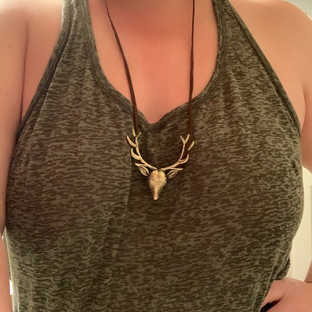 Striking gold deer pendant, leather necklace.